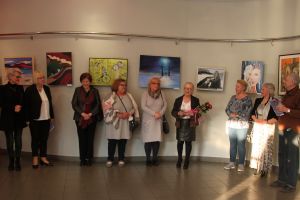 Zdjęcie: Kobiety i mężczyźni stojący w galerii MOK podczas wernisażu
